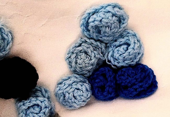 Blue and black crocheted roses.